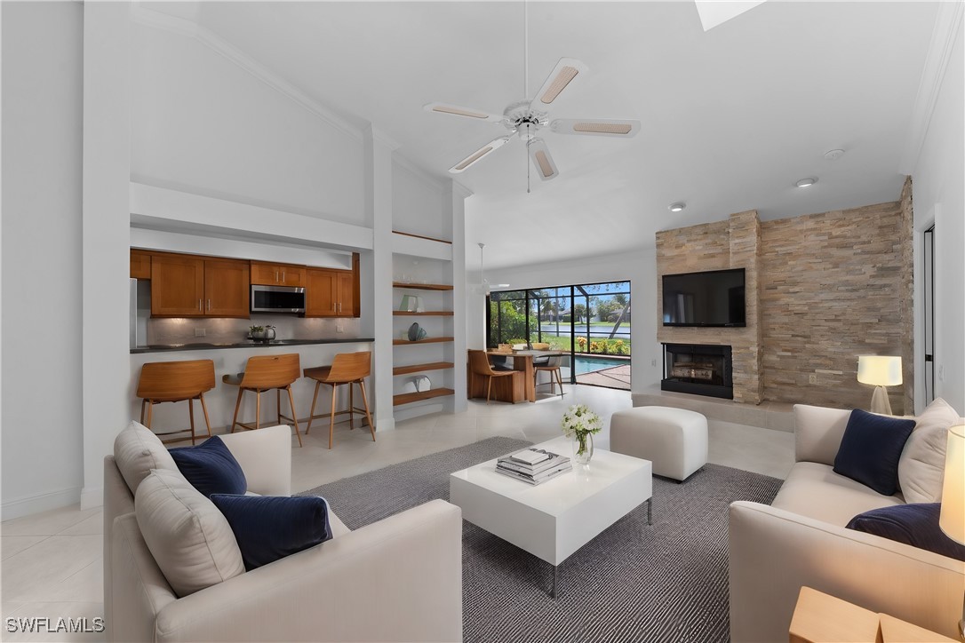 a living room with furniture kitchen view and a fireplace