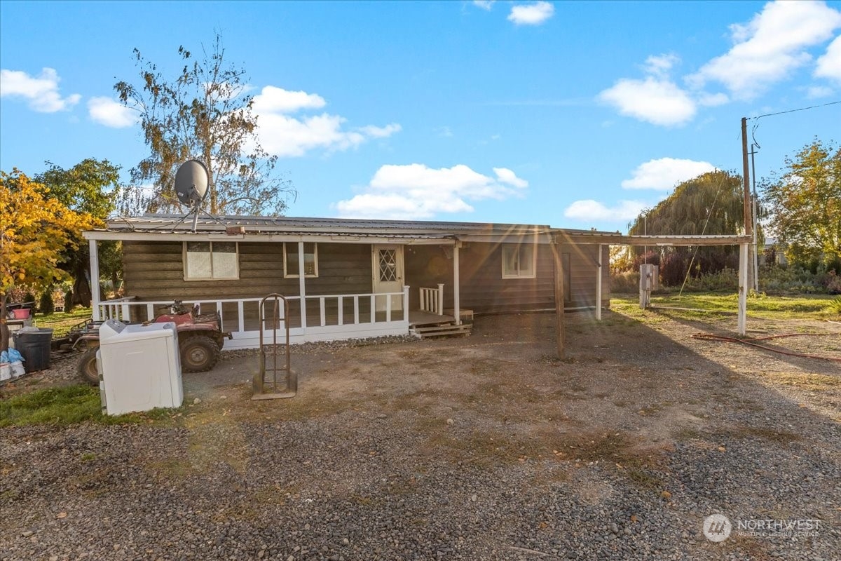 a view of a house with backyard and sitting area