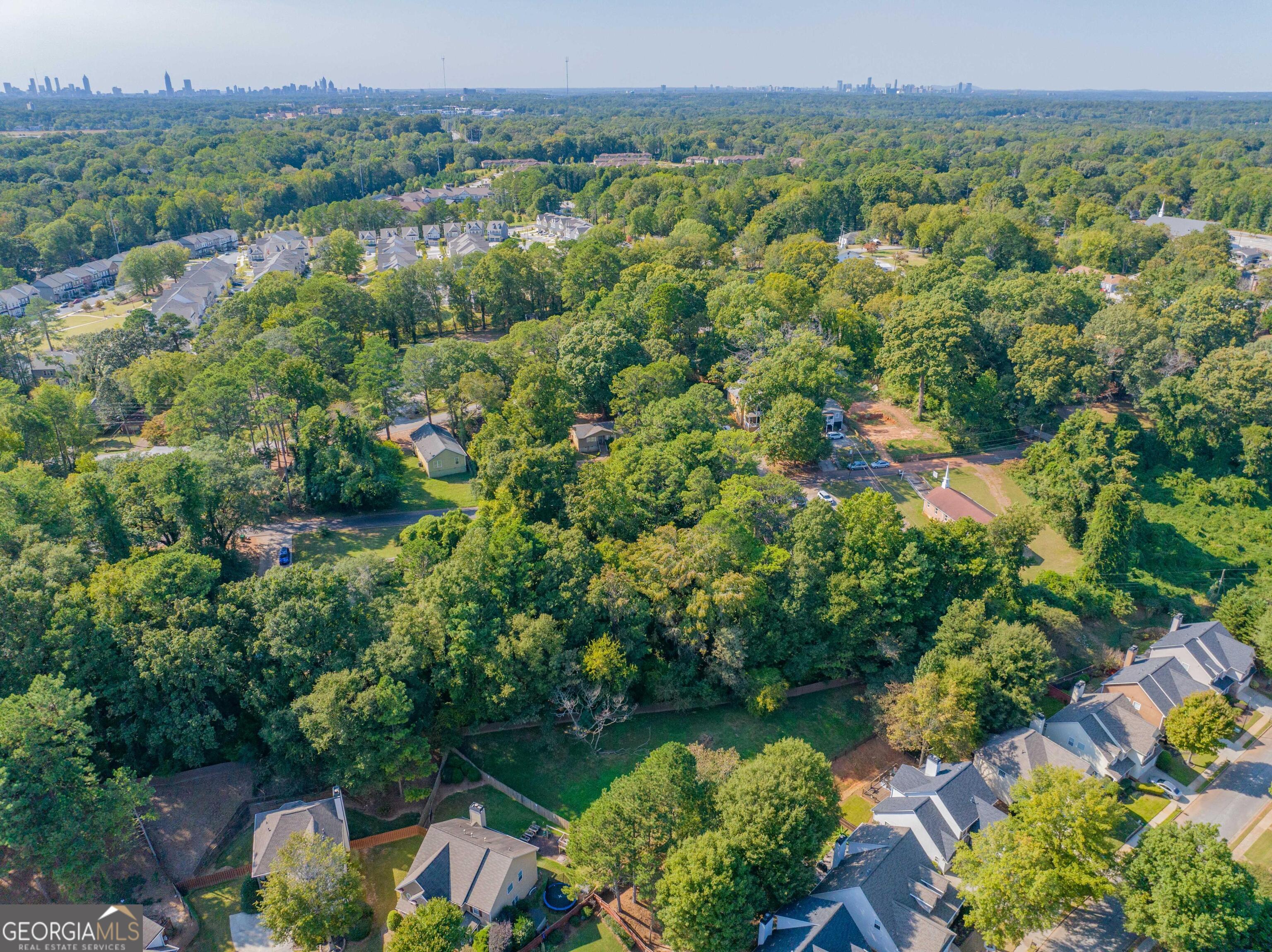 an aerial view of a houses with a yard