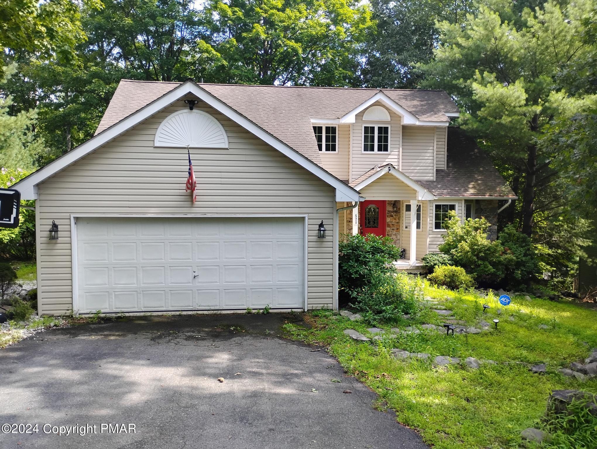 a front view of a house with a yard and garage