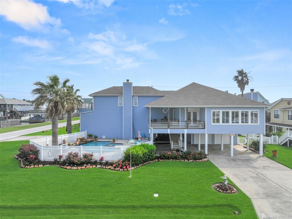 a front view of a house with a garden and yard