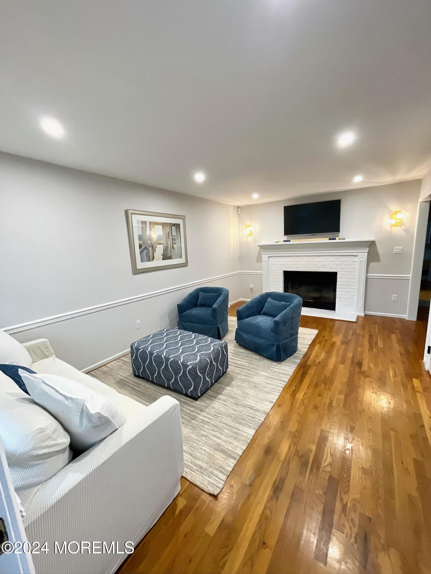 a bedroom with furniture and a flat screen tv