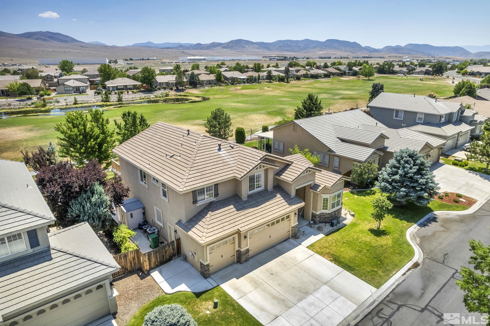 an aerial view of a house with garden space and lake view