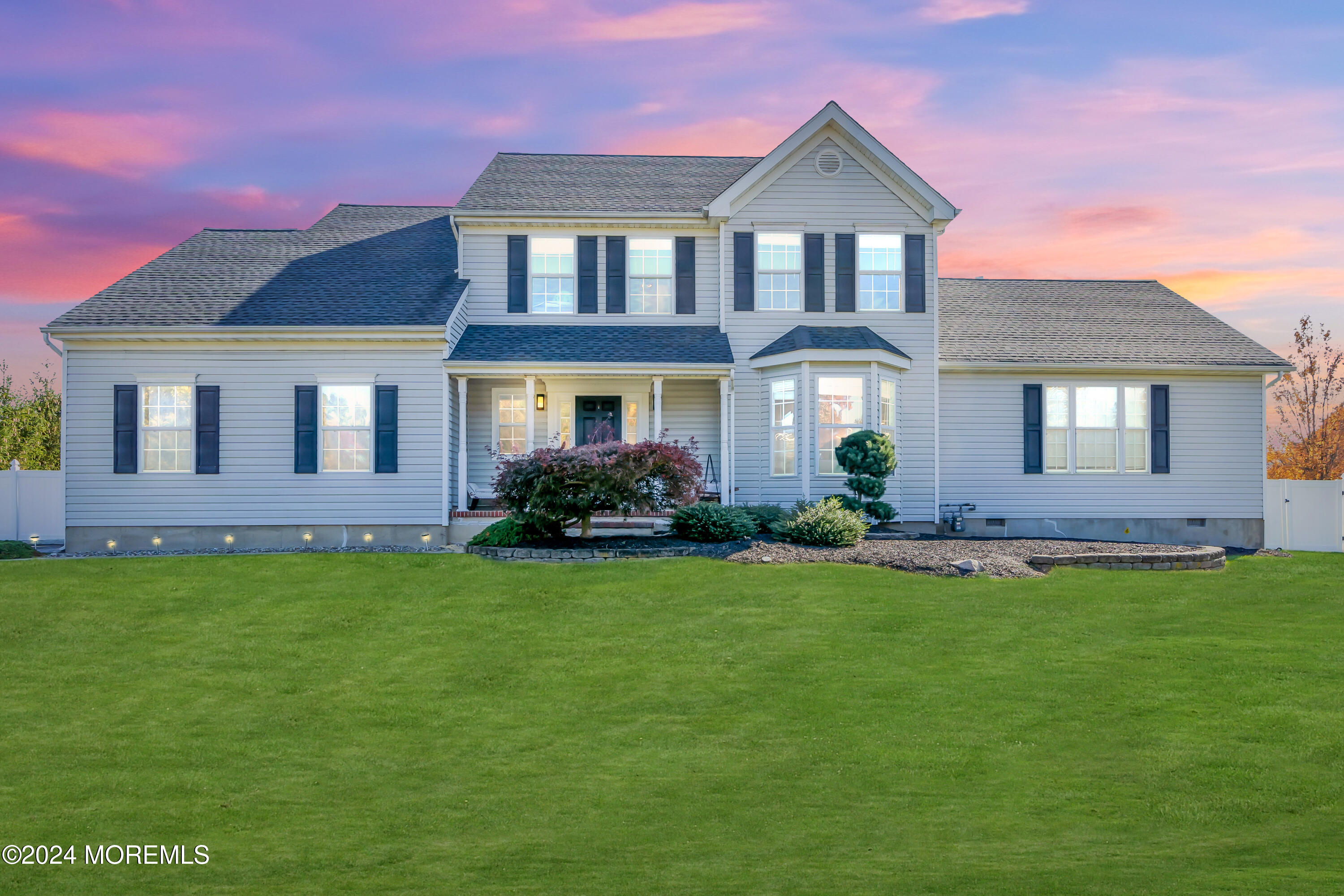 a front view of a house with a garden