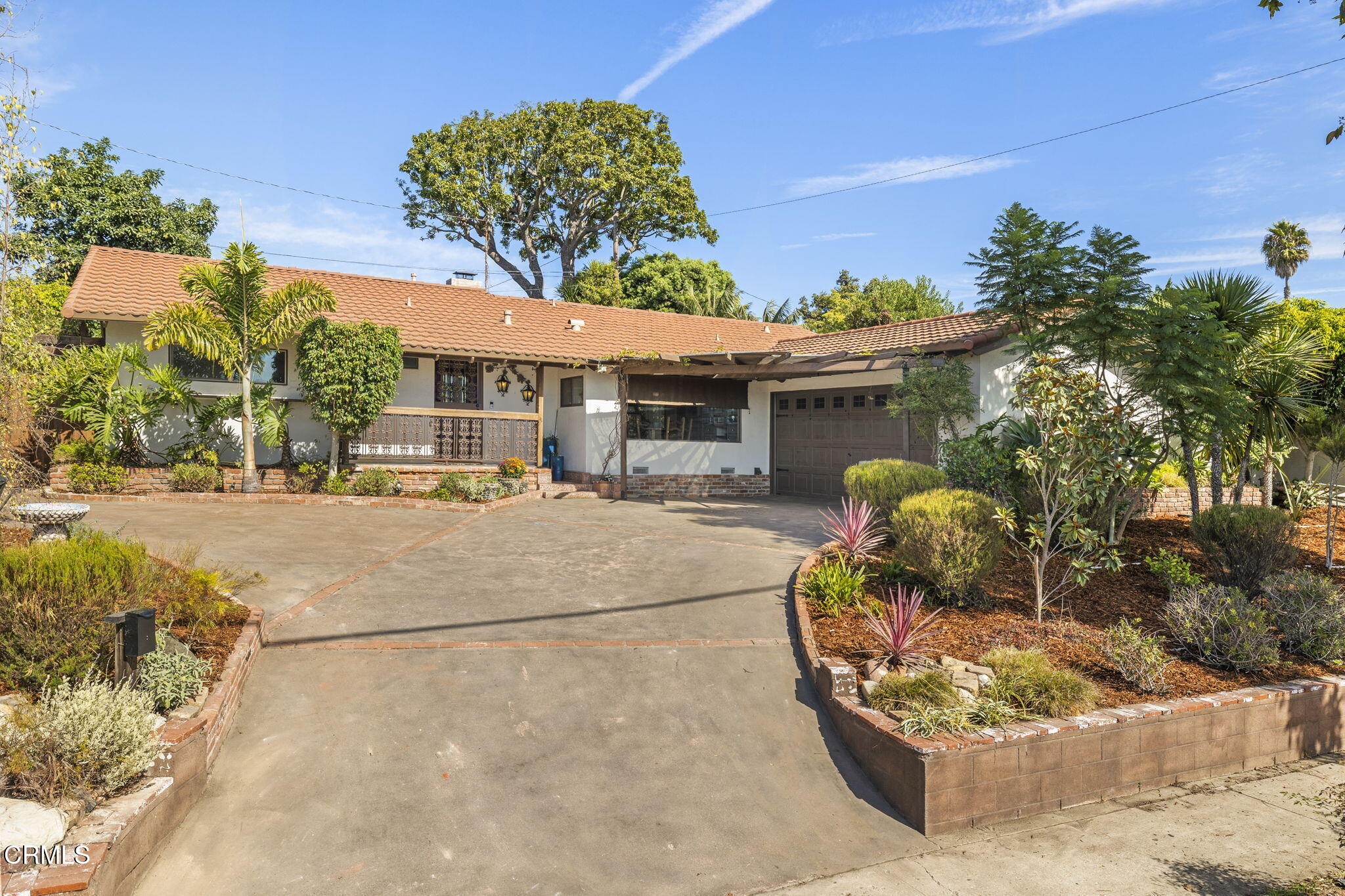 front view of a house with a tree