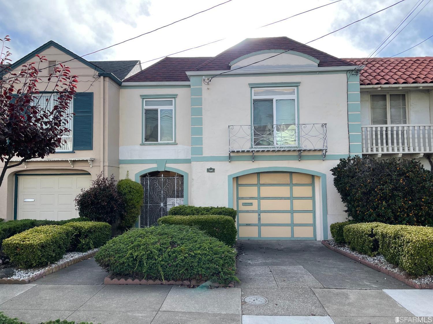 a front view of a house with a garden