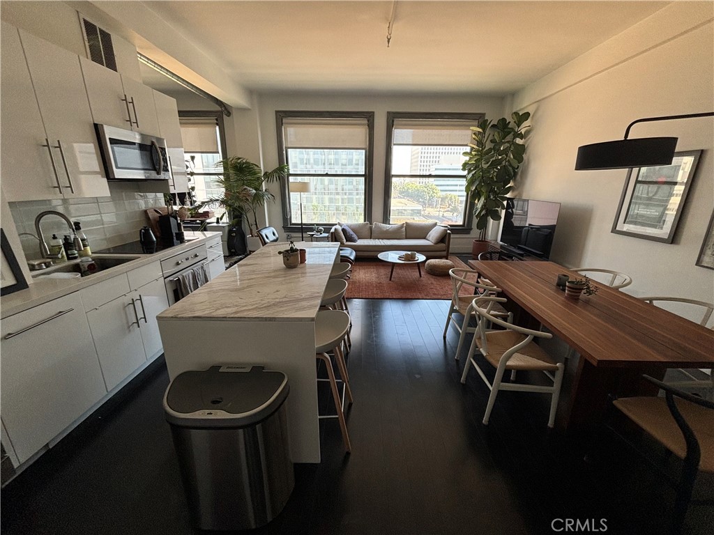 a view of a dining room with furniture and a window