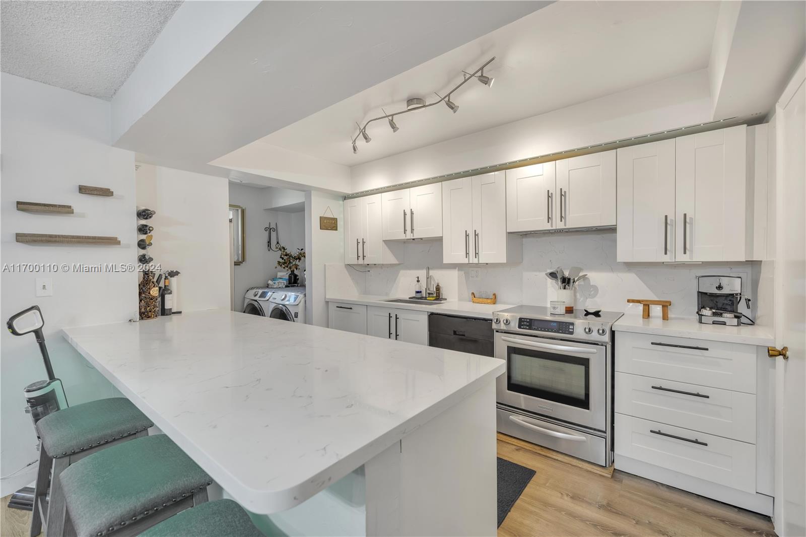 a kitchen with white cabinets and white appliances