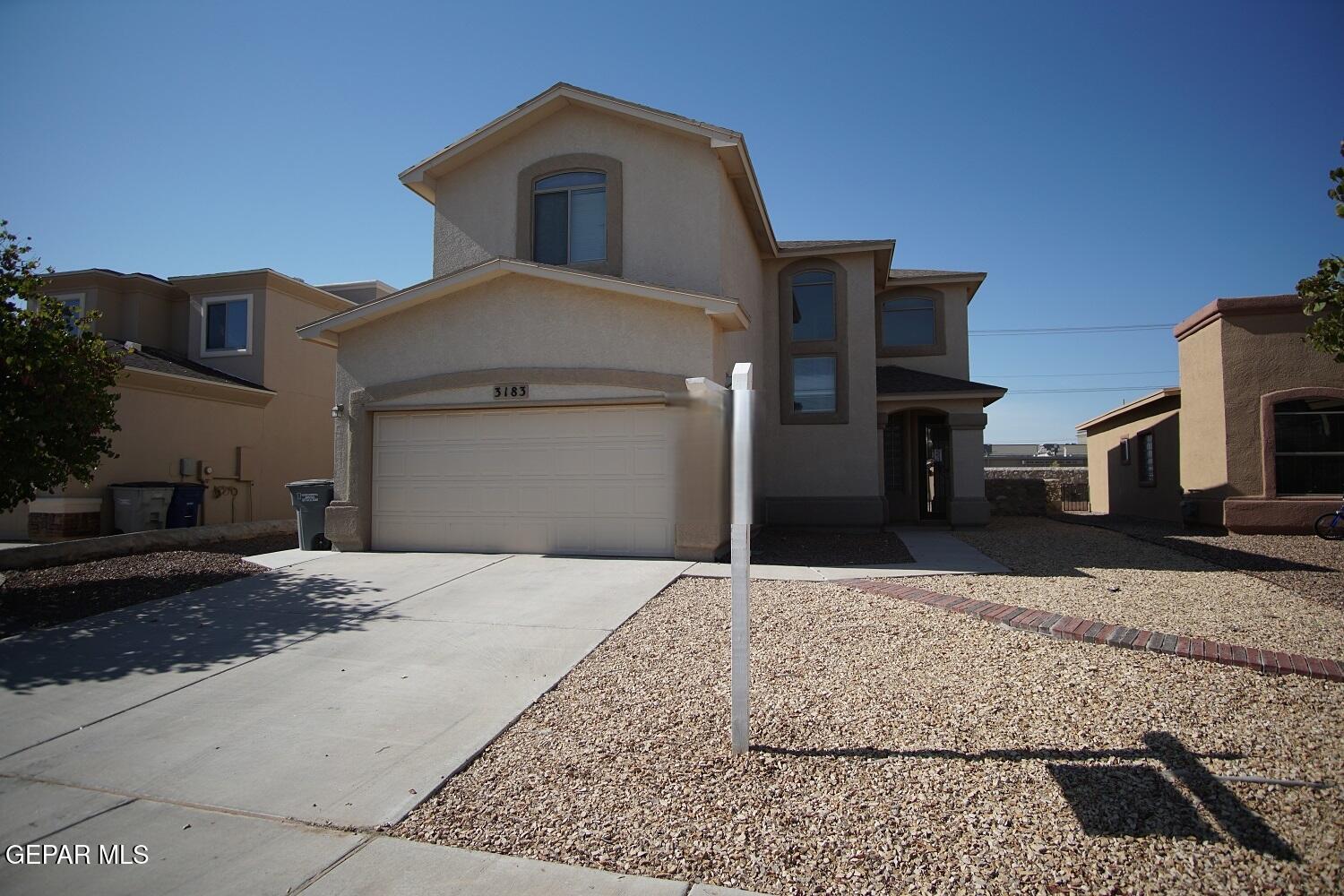 a front view of a house with parking