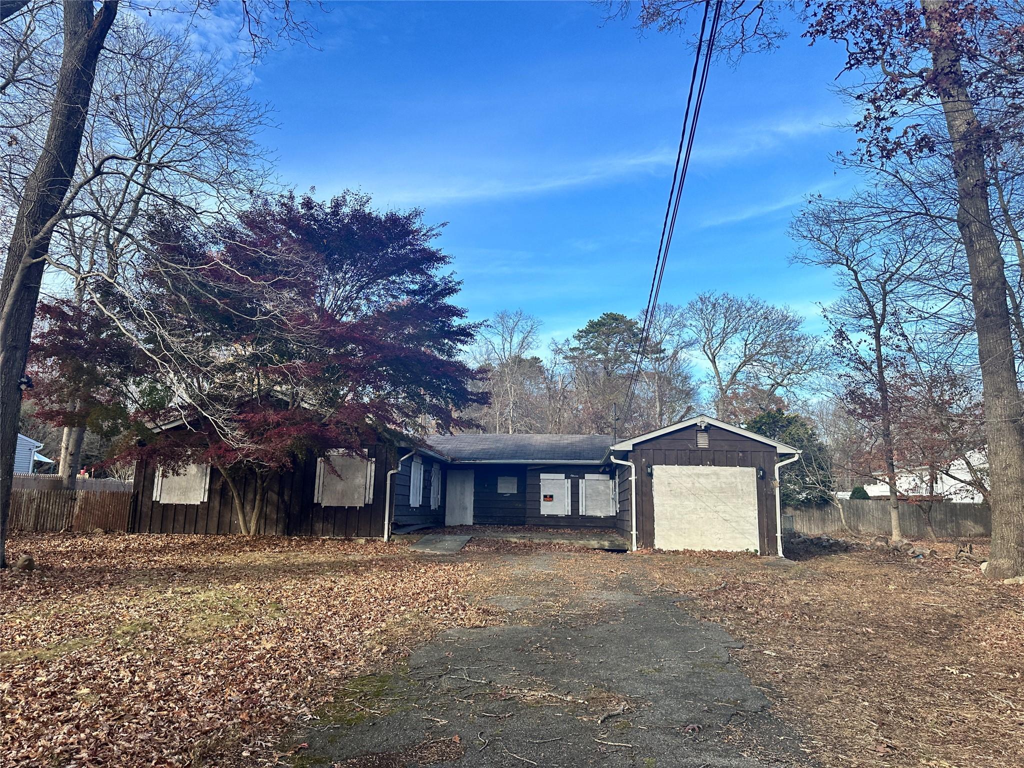 a view of a house with a yard and garage