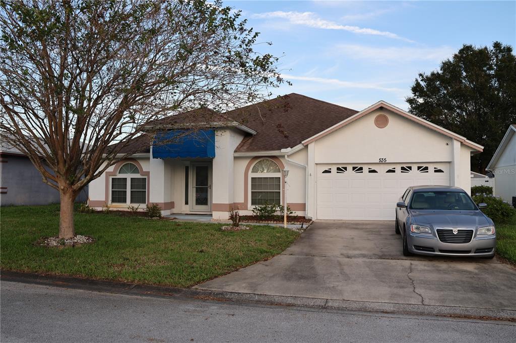 a front view of a house with a yard