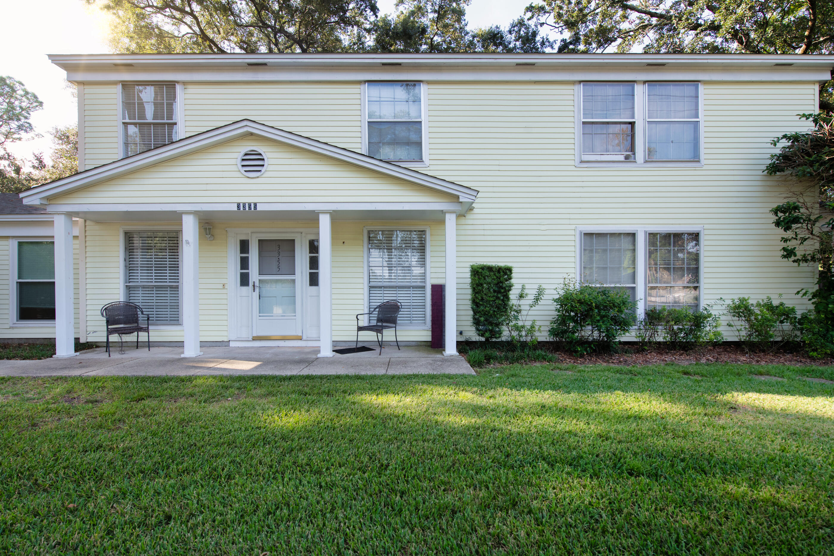 a front view of house with a garden and patio