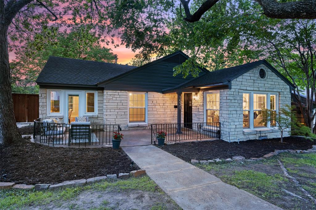 a view of a house with backyard porch and sitting area