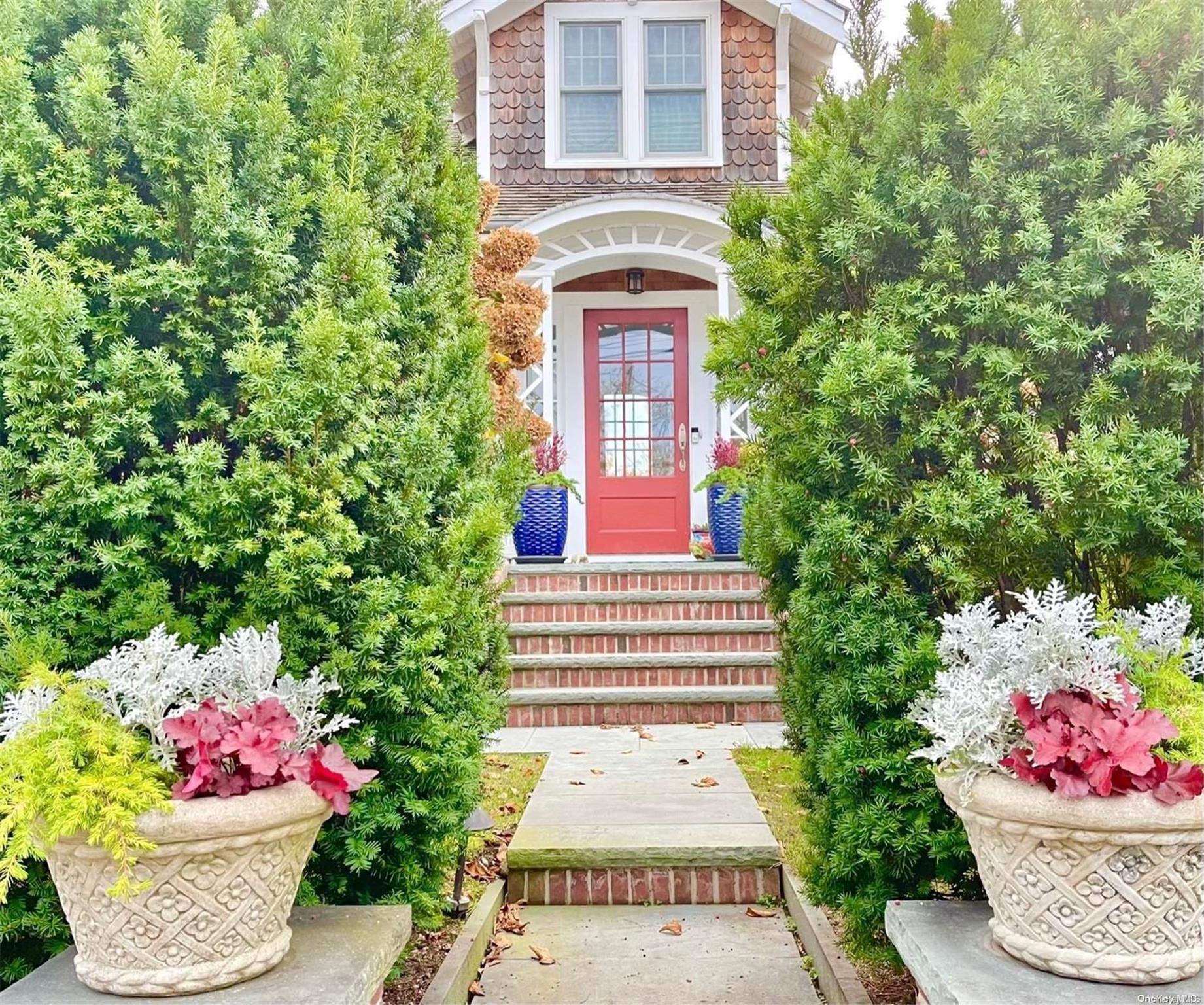 a front view of a house with a yard and flowers