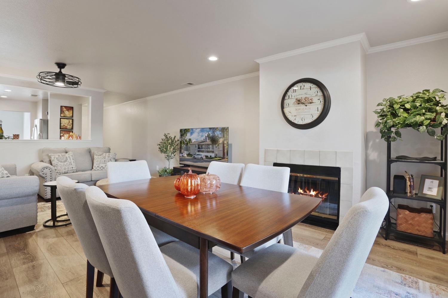 a living room with furniture a clock and a fireplace