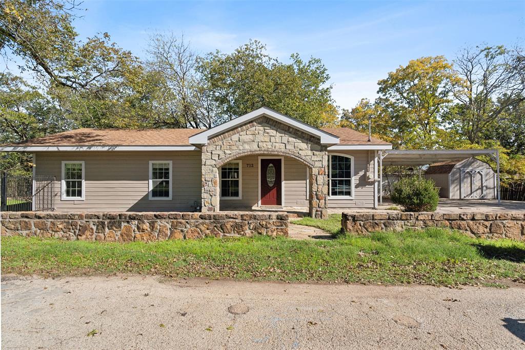 a front view of a house with garden and porch