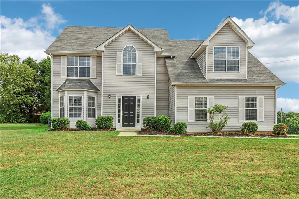 a front view of a house with garden