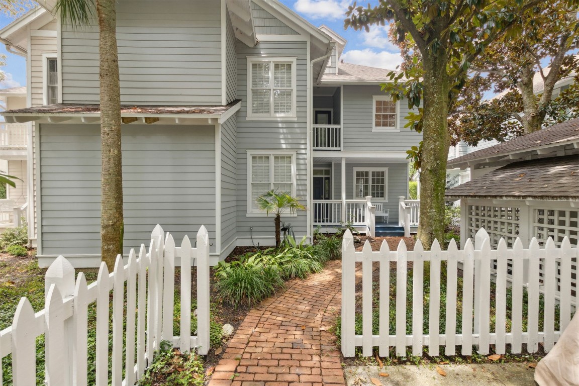 a view of a house with wooden fence