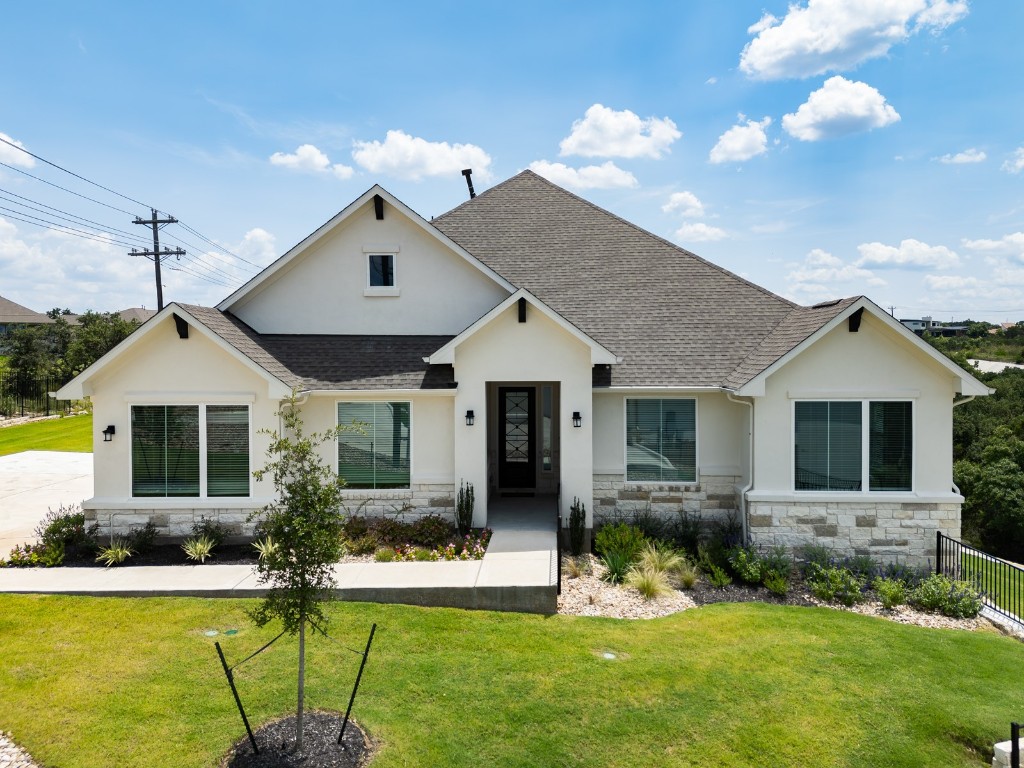 a front view of house with yard and green space