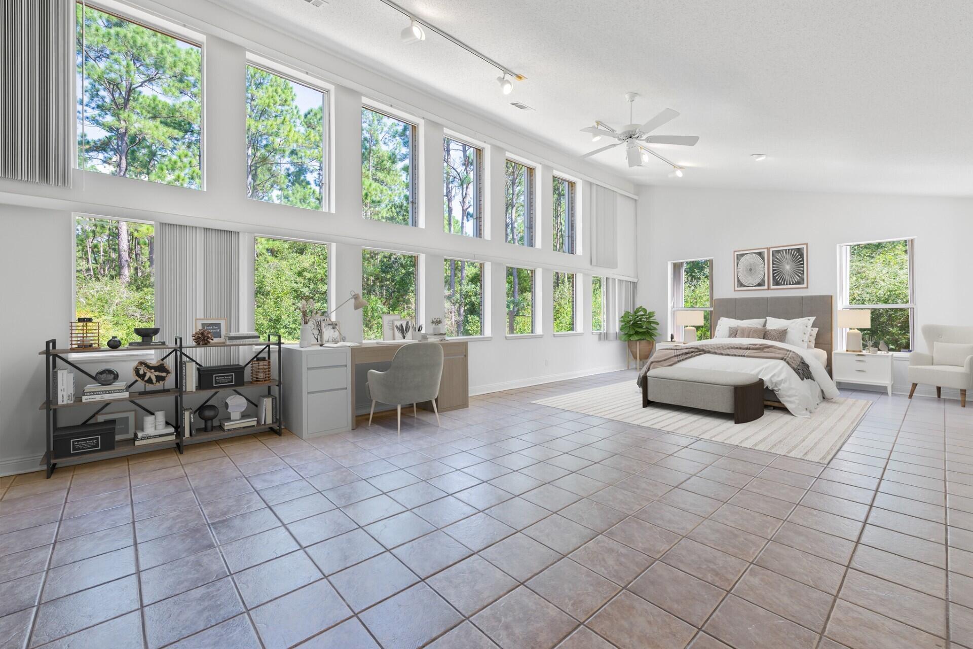 a bedroom with furniture and a large window