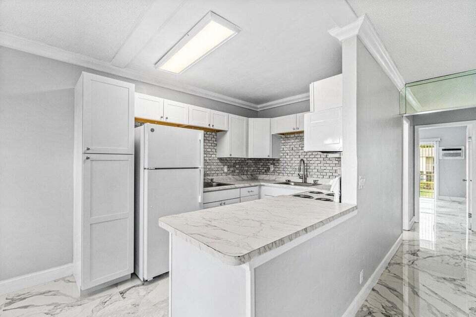 a kitchen with a refrigerator and a sink