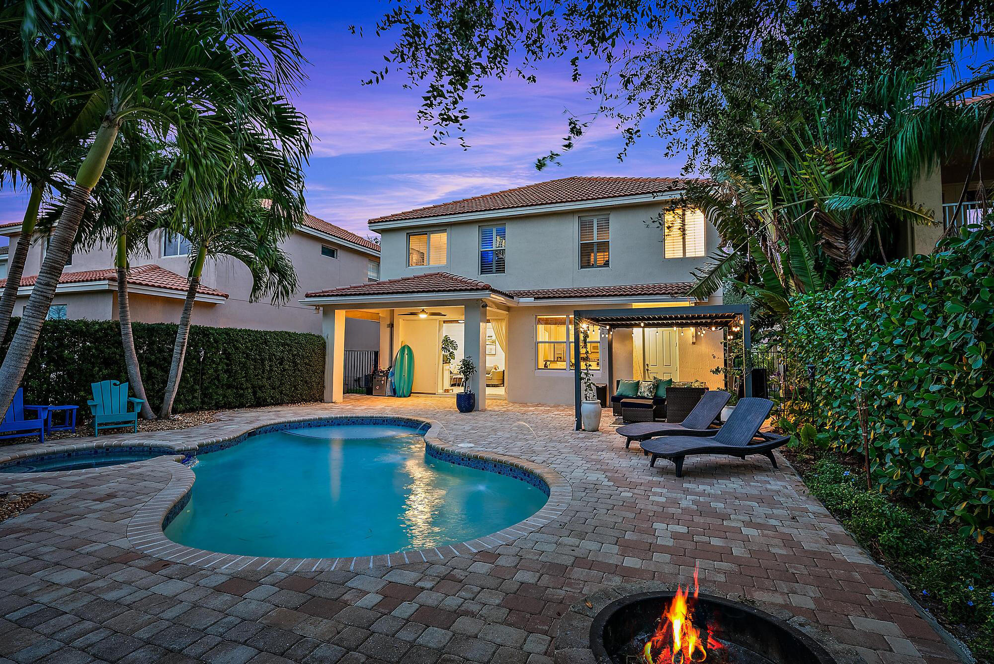 a view of a house with swimming pool and sitting area