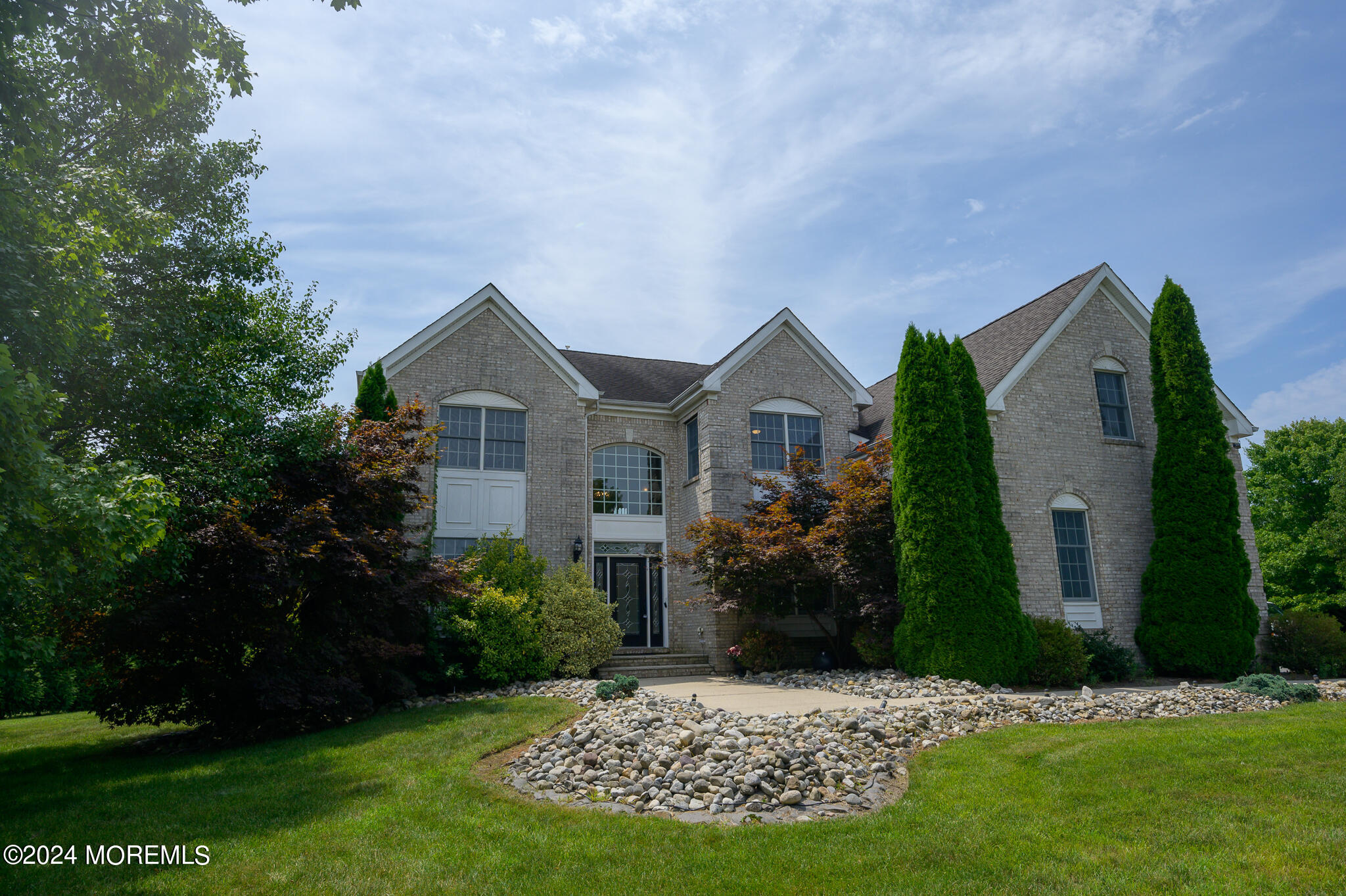 a front view of house with a garden