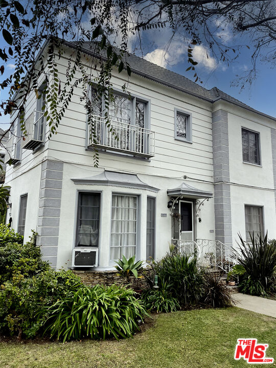 a view of a house with potted plants