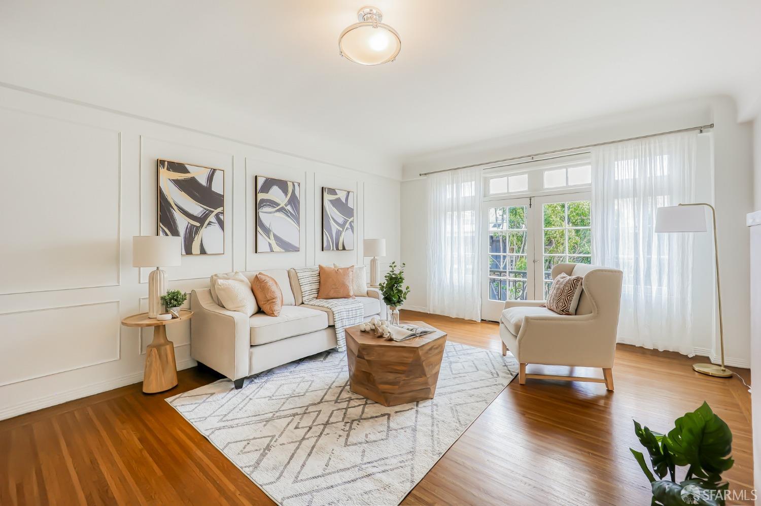 a living room with furniture and wooden floor