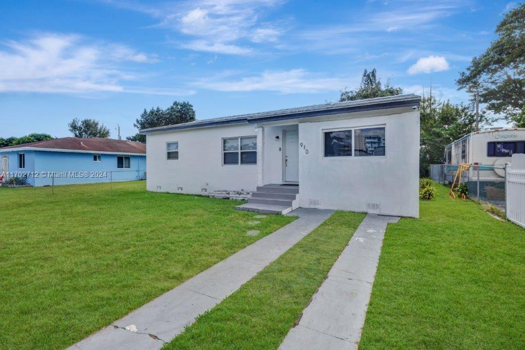 a view of house with backyard