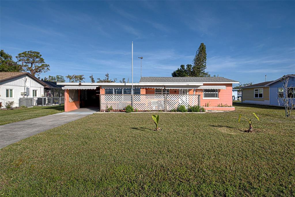 a view of a house with a yard and sitting area