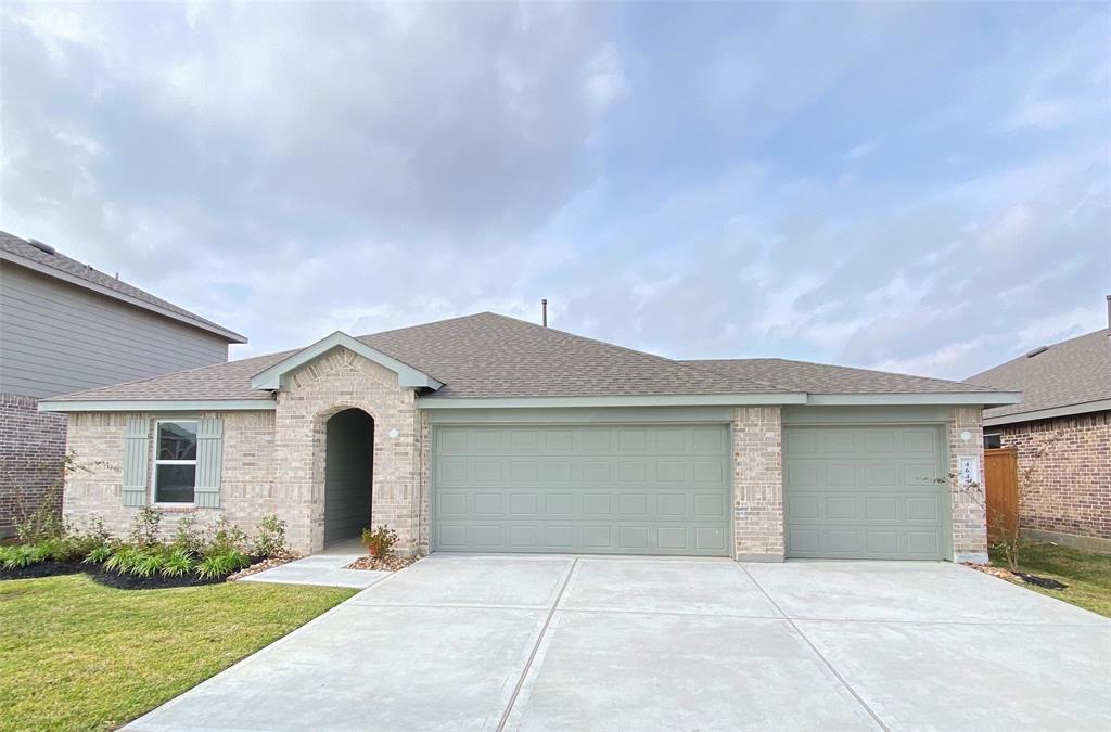 a front view of a house with yard and garage