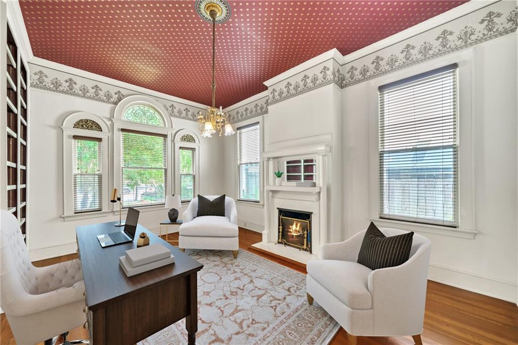 a living room with furniture fireplace and a large window