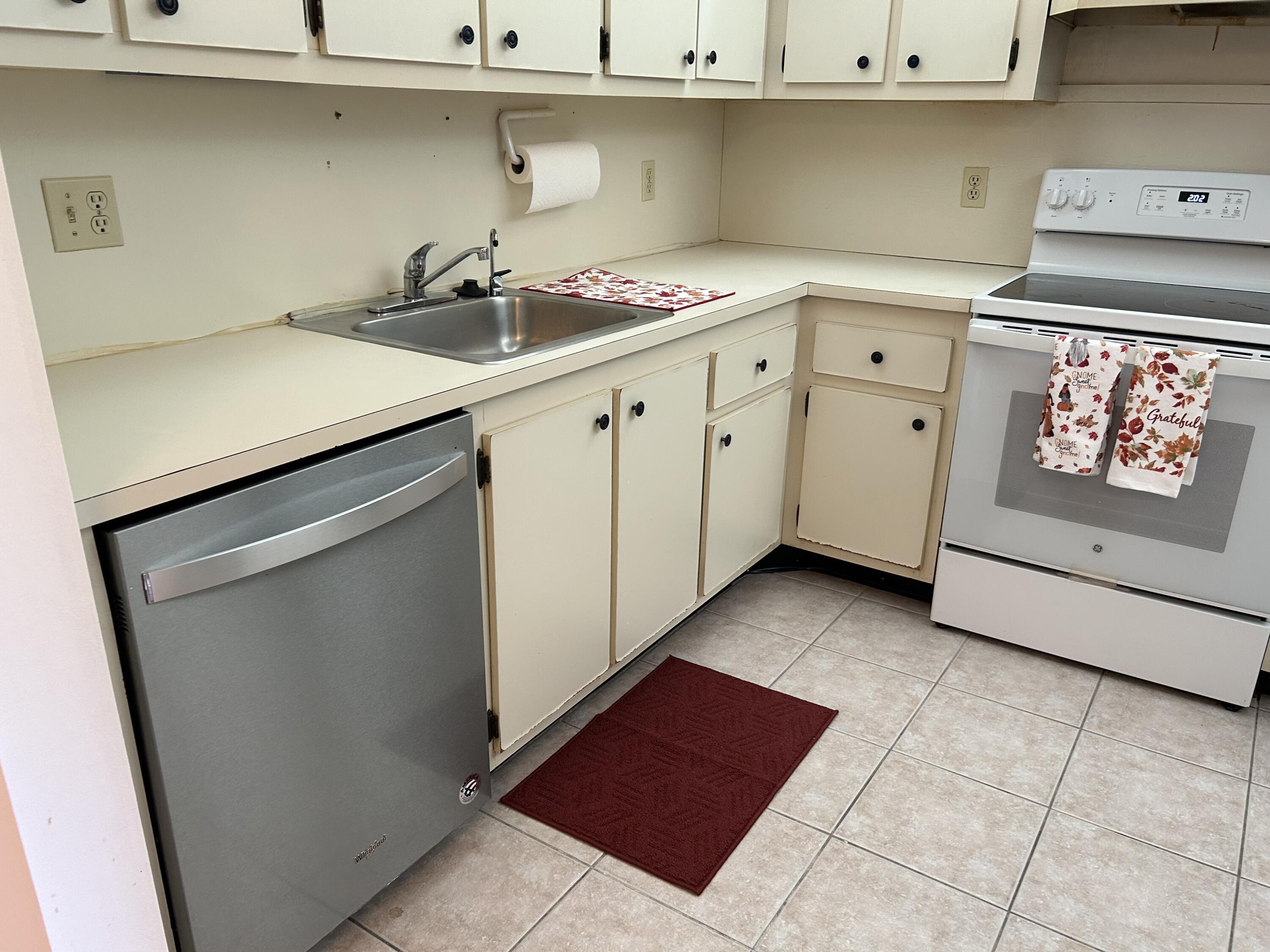 a kitchen with a sink cabinets and a stove