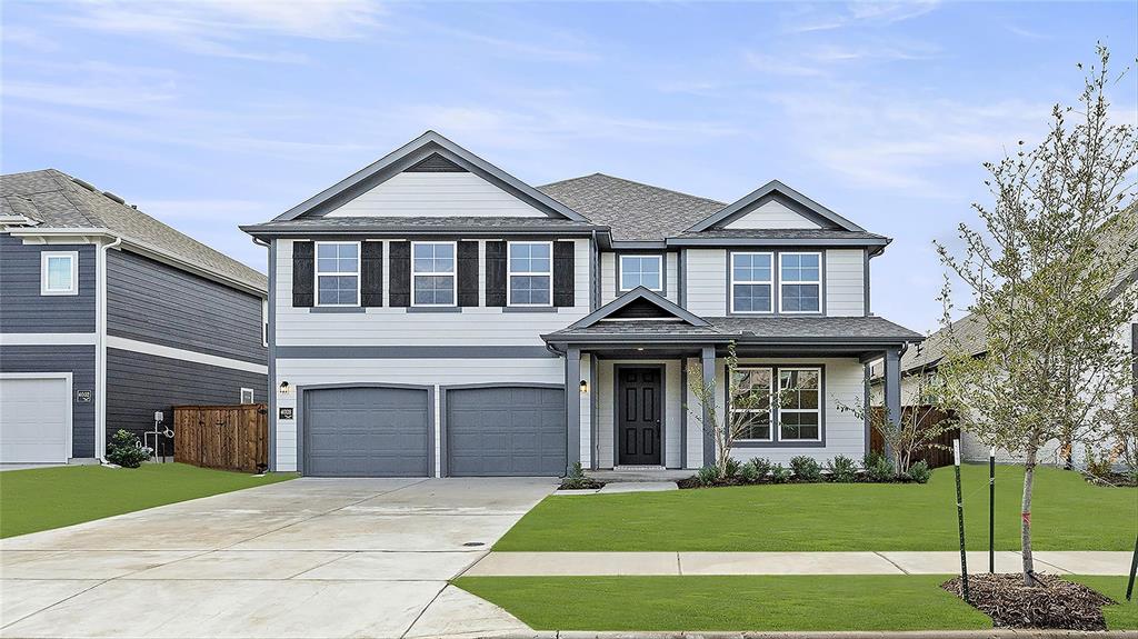 a front view of a house with a garden and yard