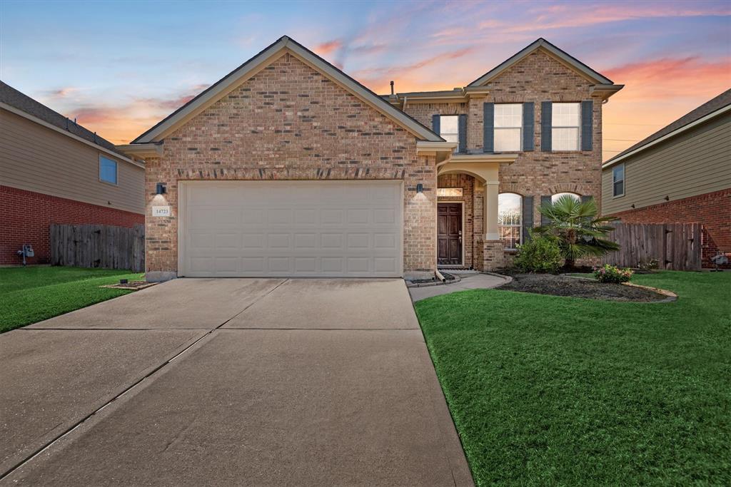 a front view of a house with a yard and garage