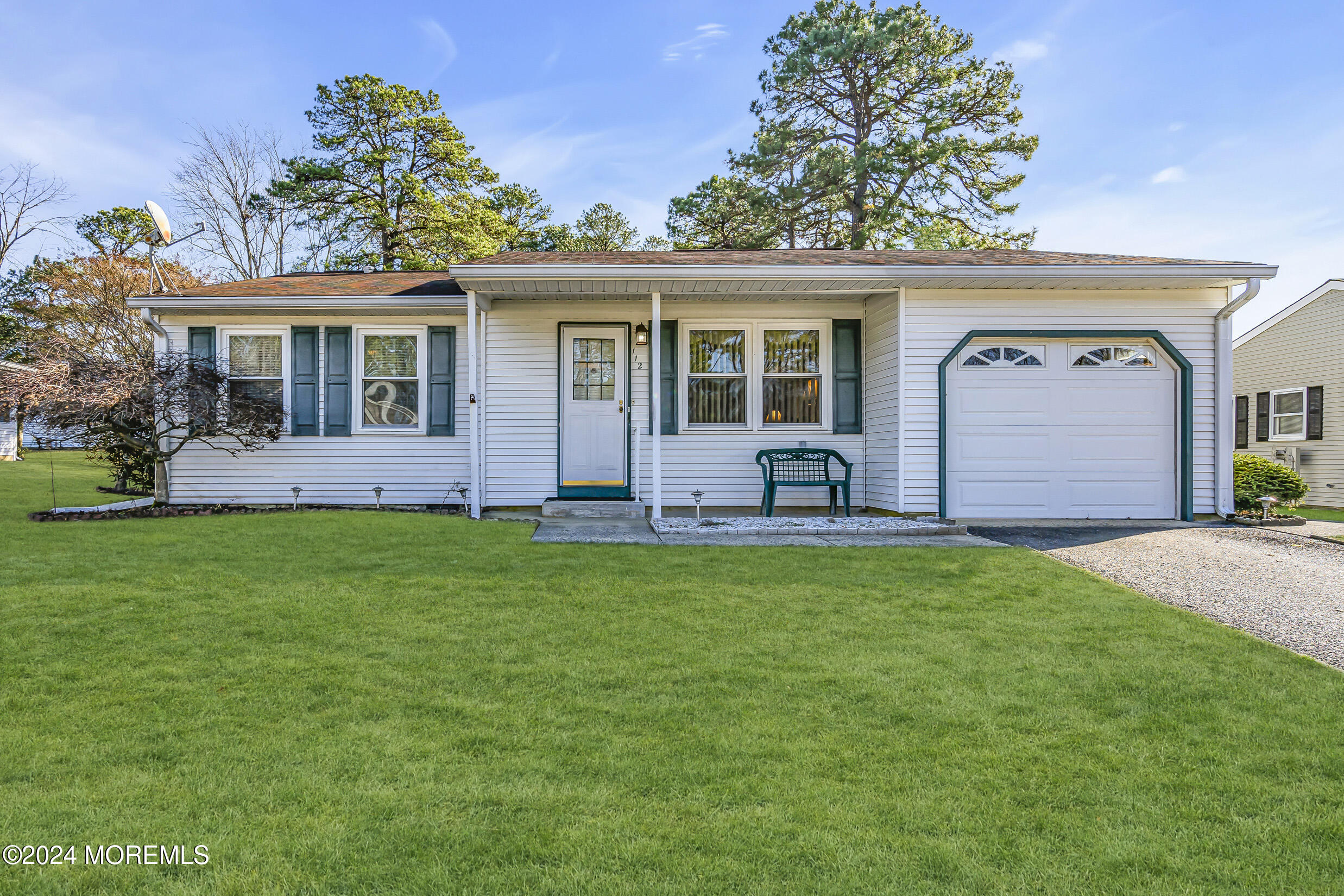 a front view of a house with a garden and porch