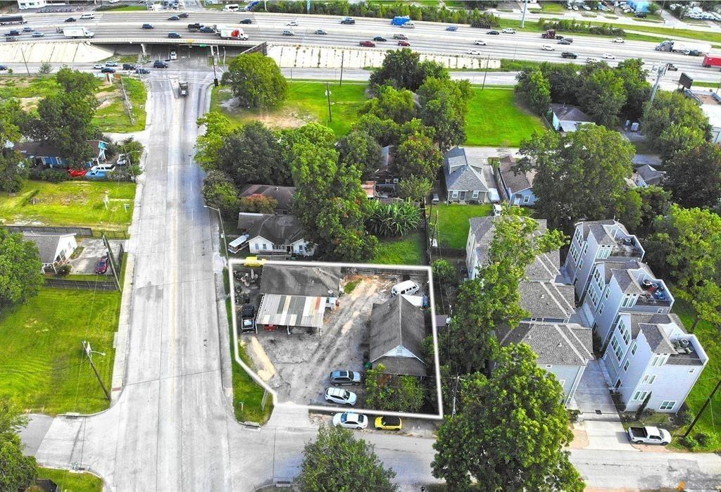 an aerial view of a house with a yard swimming pool and outdoor seating