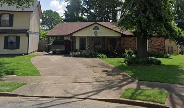 a front view of house with yard and green space