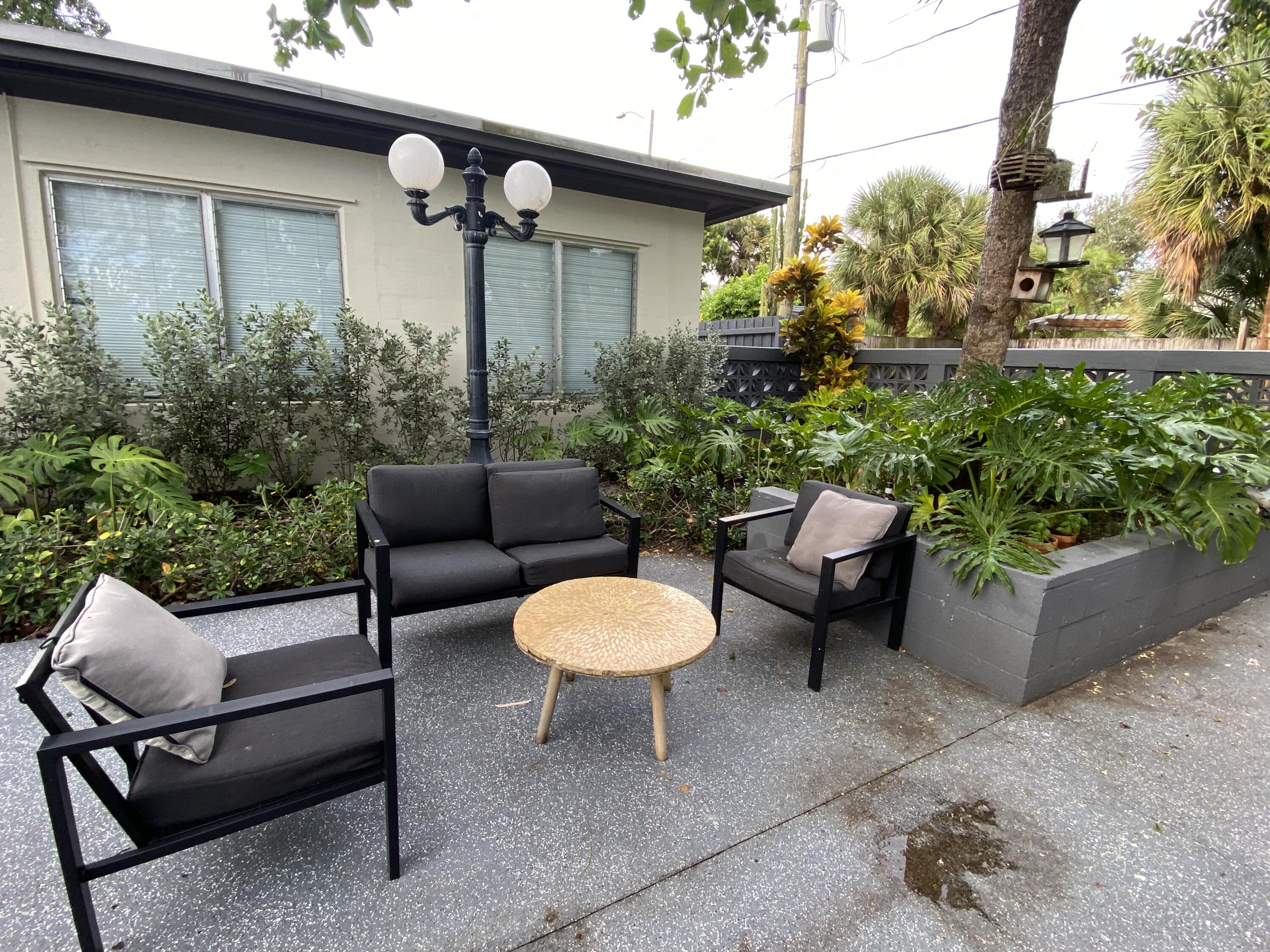 a backyard of a house with outdoor seating