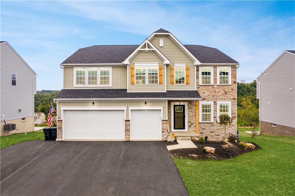 a front view of a house with a yard and garage