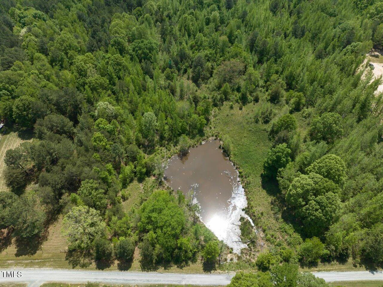 an aerial view of a house with a yard and lake view