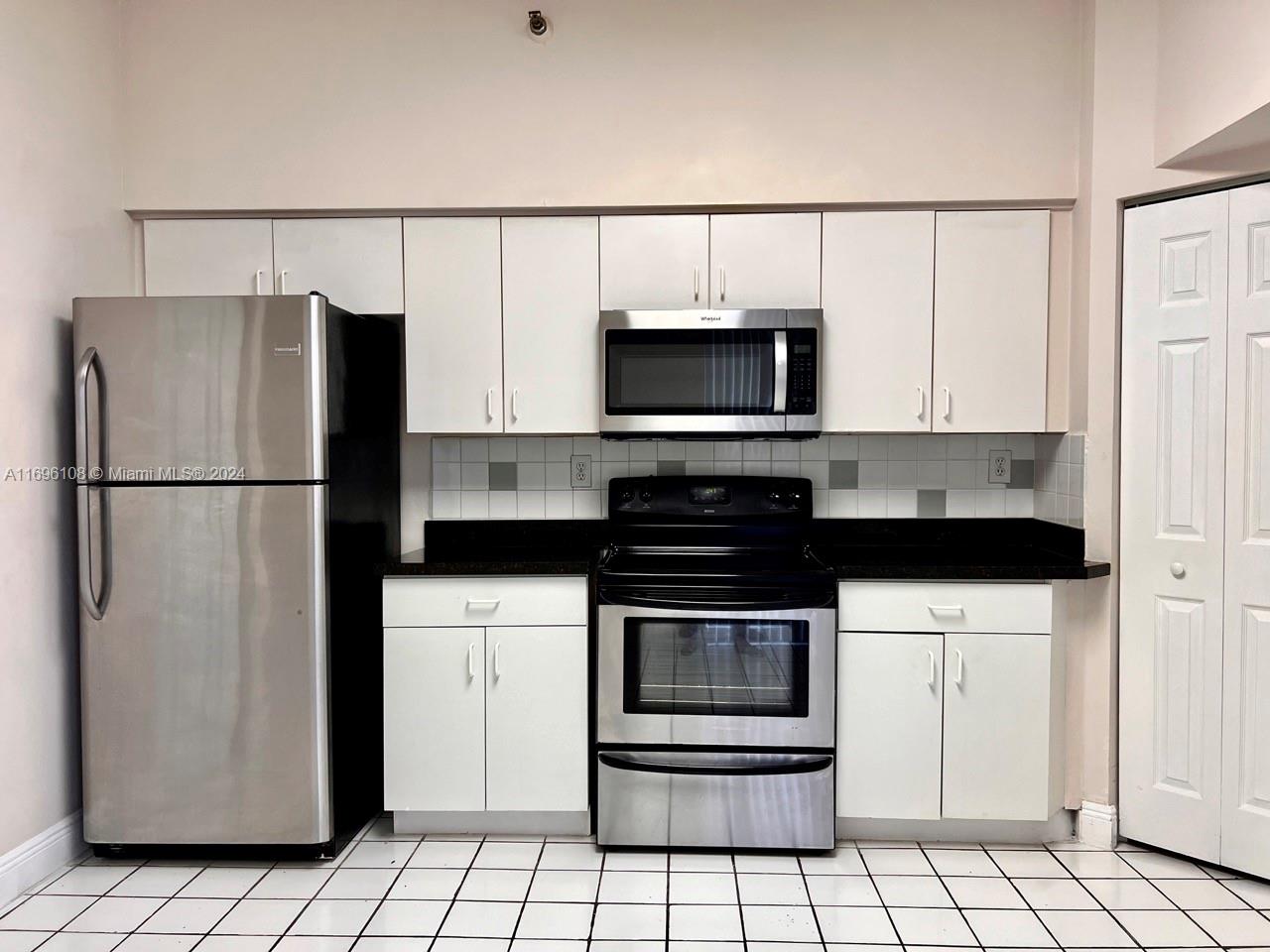 a kitchen with a refrigerator stove and microwave