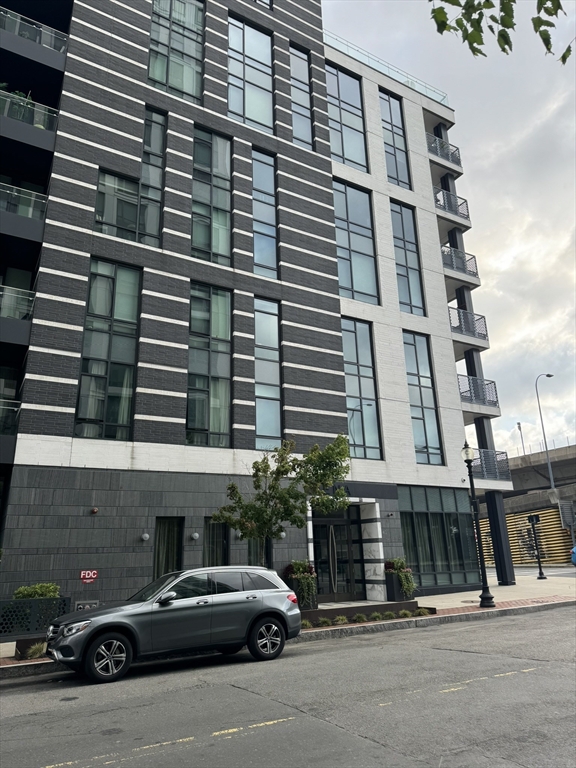 a couple of cars parked in front of a building