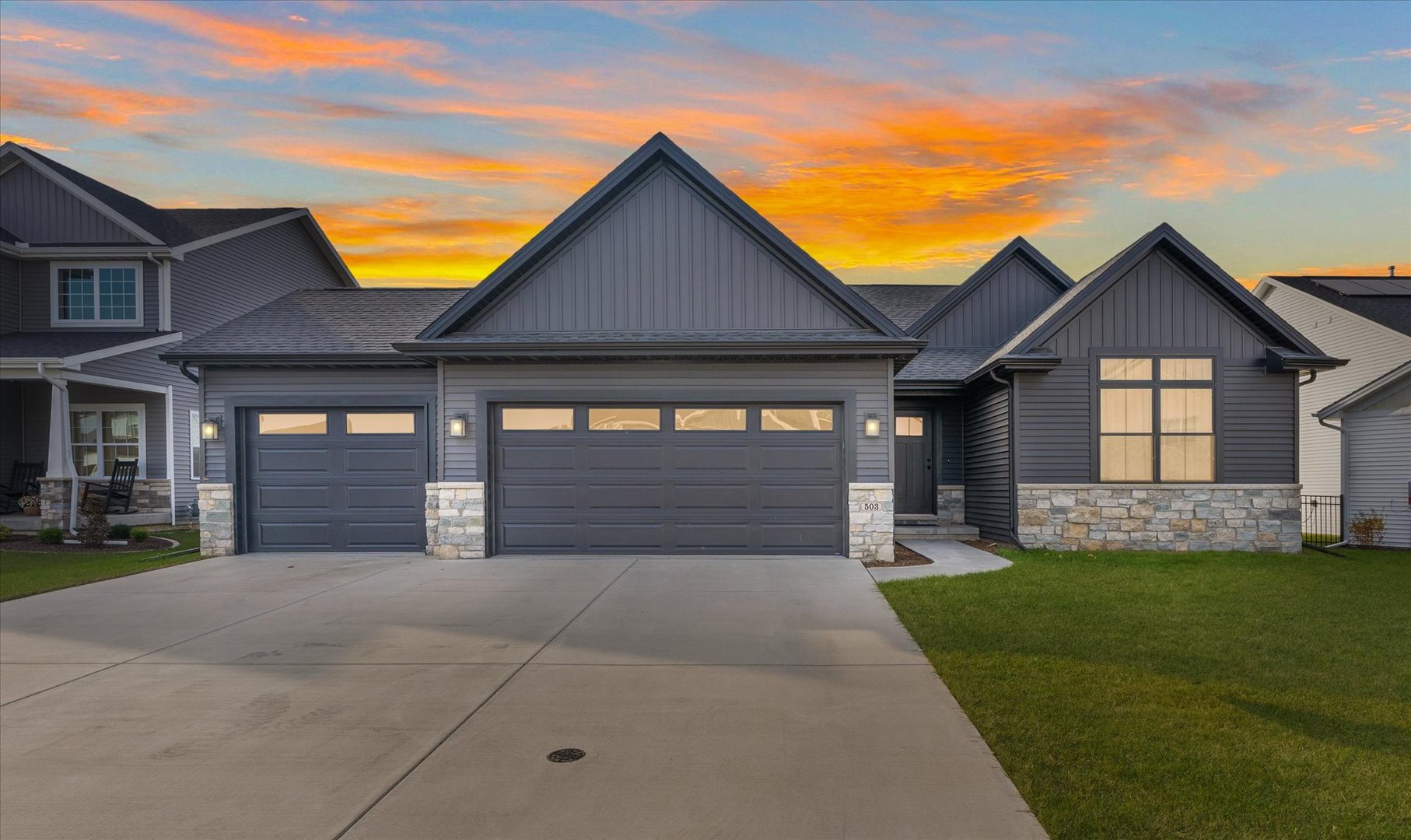 a front view of a house with a yard and garage