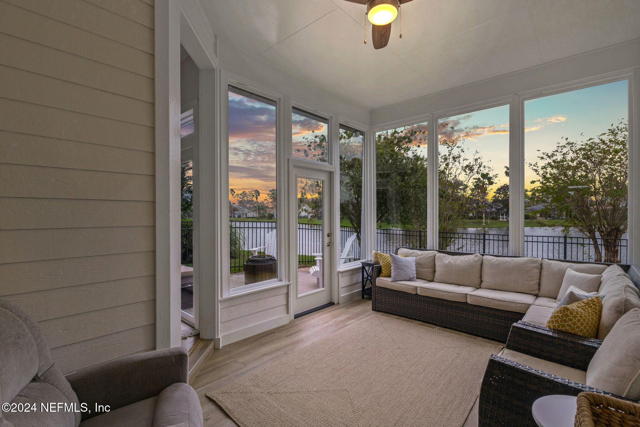 a living room with furniture and a floor to ceiling window