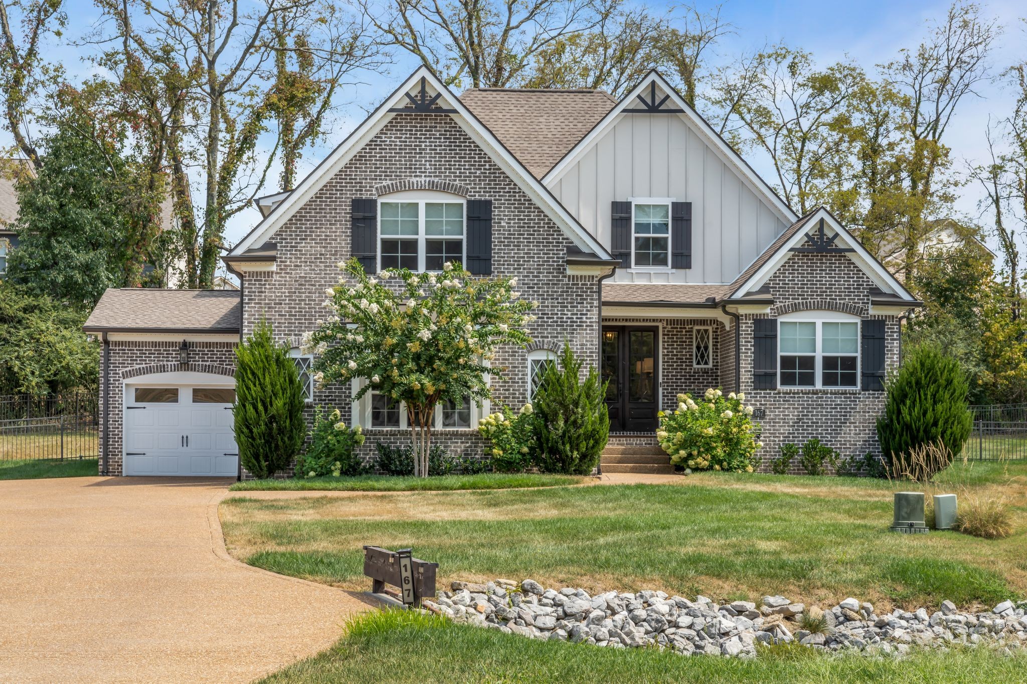 a front view of house with a garden