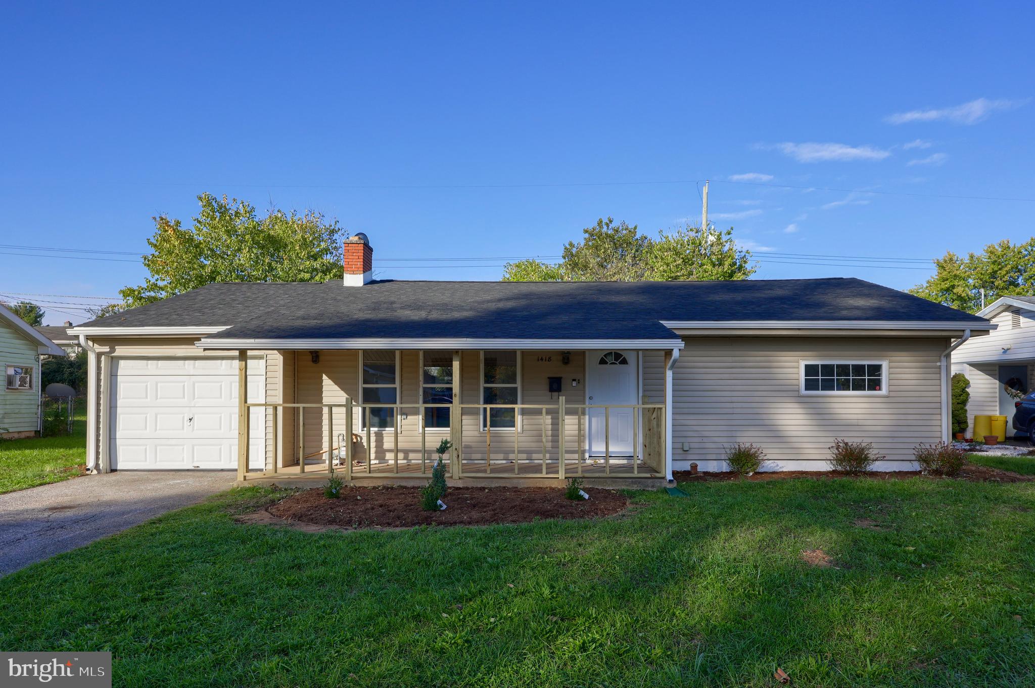 a front view of house with yard and outdoor seating