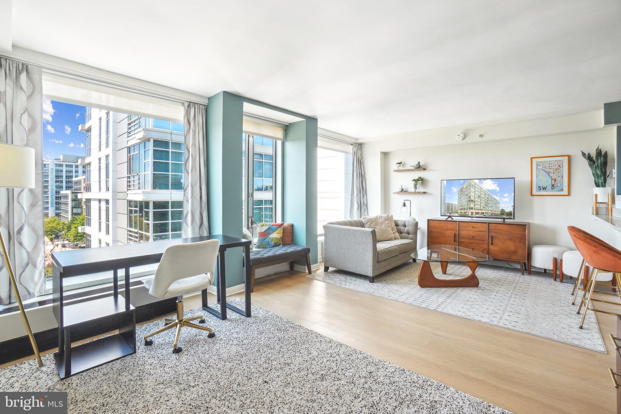 a living room with furniture and a large window