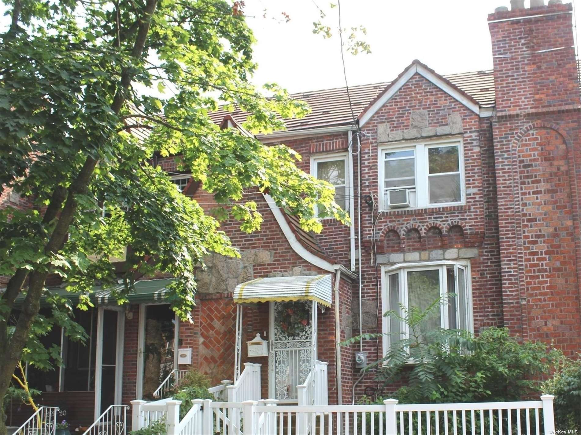 front view of a house with a tree